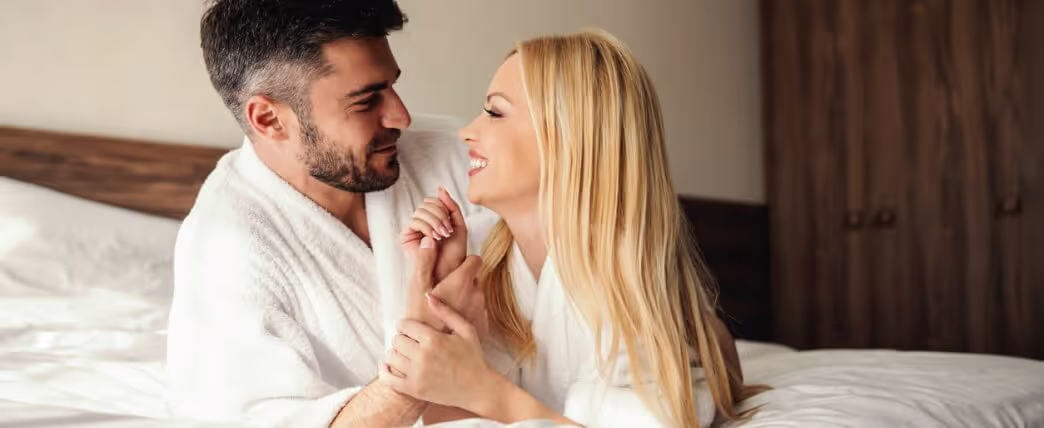 A couple lying in bed getting romantic to increase their sex drive
