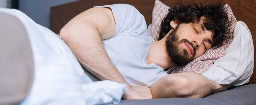 Man sleeping on side, which is the best sleep position for sleep apnea