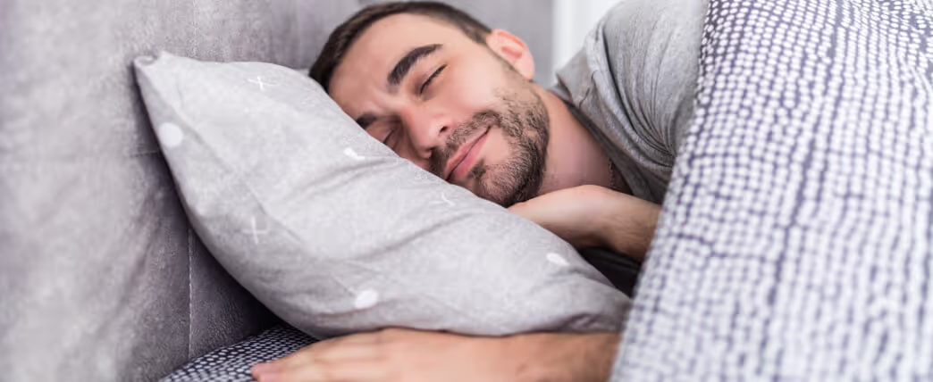 Man sleeping on his side, which is one sleeping position to lose weight