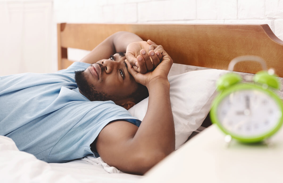 Sleep efficiency: Man who can't sleep lying awake in bed
