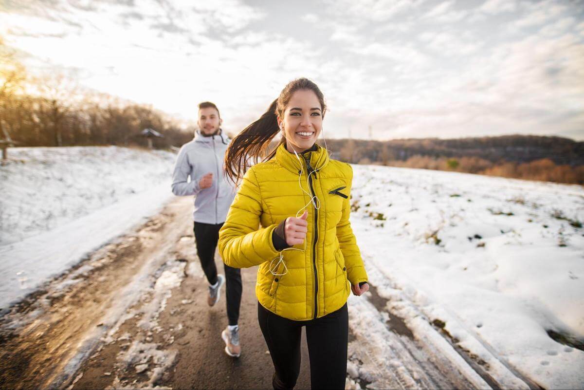 Two people jogging during the winter